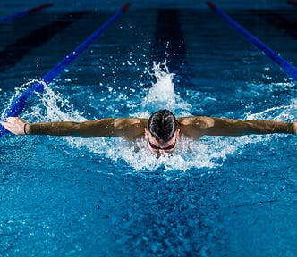 A head-on view of swimmer mid butterfly stroke