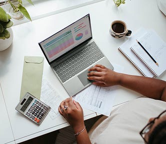 women, woman, at office, black woman typing, black woman laptop, Women’s Pressure To Perform And Competitive Social Structures, Womens Pressure, performance, work, competition, sociology, psychology, Competitive Social Structures