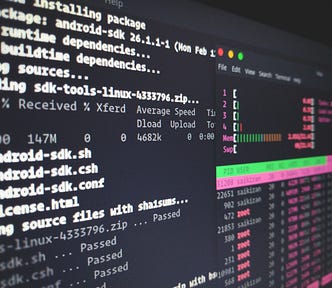 Computer screen with code and HTOP