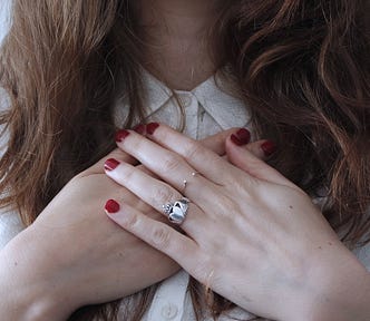 women holding her hands across her chest