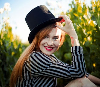 A happy woman has fun in a meadow