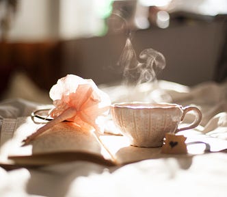 A hot beverage sitting atop a journal