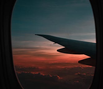 view of an airplane wing and the sky