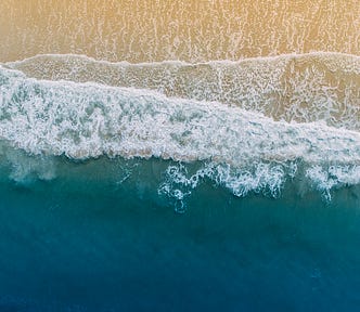 Ariel view of sea meeting sand.