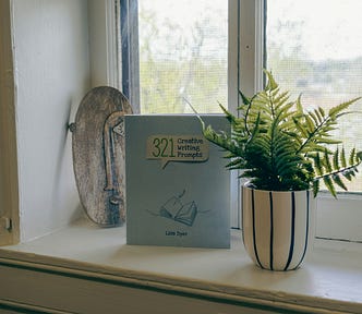 Plant pot with writing prompts on a windowsill