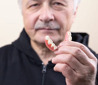 Man showing his denture.