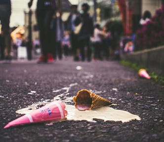Ice cream melting on a pavement