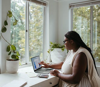 woman sitting at her desk in front of her computer