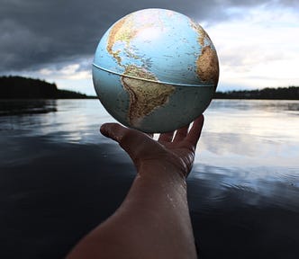 hand holding out globe