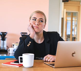 A bored woman in front of the computer