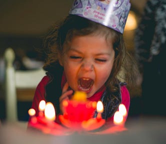 Girl blowing out birthday candles