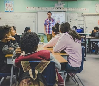 Students listening to a teacher