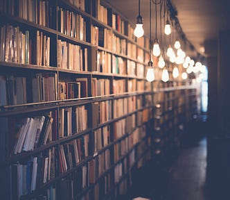 Photo of shelves upon shelves of books down a long corridor