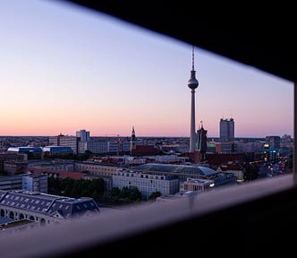 Pink and blue sunset skies. City skyline view of Berlin, Germany with the TV Tower, as seen through a ledge