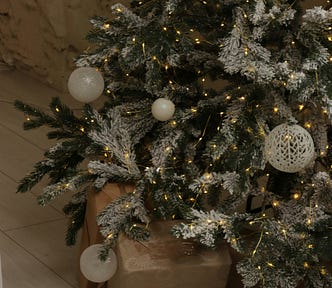 Close up of a Christmas tree with matching white bulb decorations.