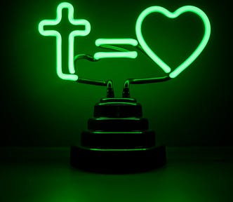 Everyday Life Betrayal, The Painful Reality Of The Crucifixion. A neon green sign with a cross symbol, a plus sign, and a heart, which means the cross equals love.