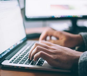 person typing on a laptop