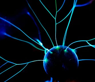 Image of a glowing ball or brain cell with fibres coming out of it, on a black background.