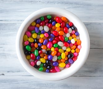 A large white ramekin of assorted colored jelly beans.
