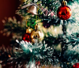 A Christmas tree with ornaments hanging on it