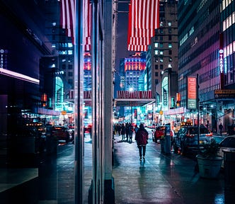 American flag above street at night