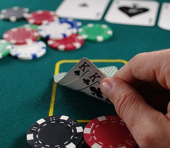 Man playing poker showing his cards