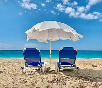 set of beach chairs with an umbrella