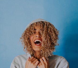 Winners are grinners…image shows woman laughing.