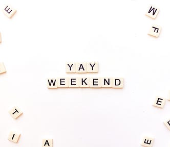 Scrabble letters that spell “YAY WEEKEND”