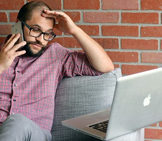 A worker takes a stressful phonecall