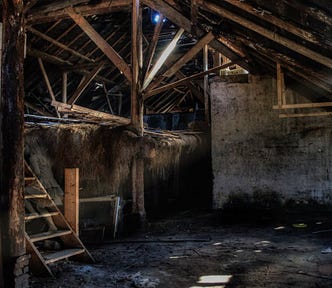 Dingy empty basement with rickety stairs.