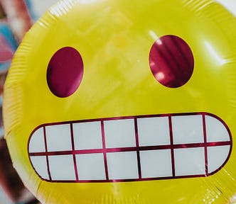 A baloon of an akward face emoji.