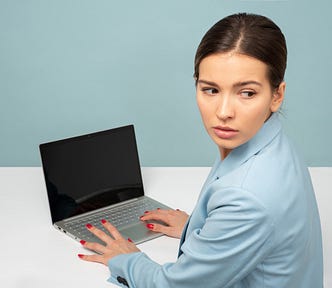 woman on a laptop looking over her shoulder
