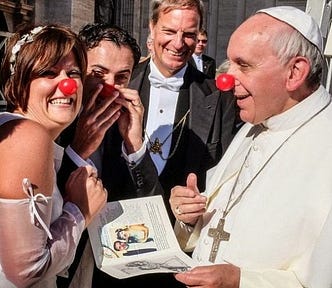 the Pope, wearing a clown nose, with a lady wearing a clown nose