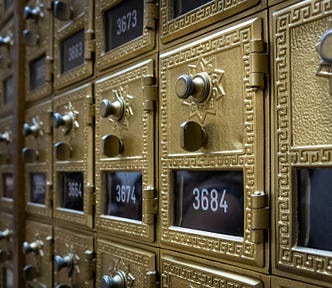 A row of vintage mailboxes inside an old post office.