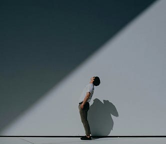 a young man leaning back and looking at the sky