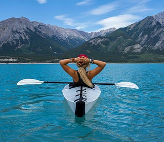 woman kayaking on a blue lake