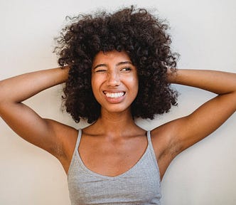 Charismatic black woman against white wall