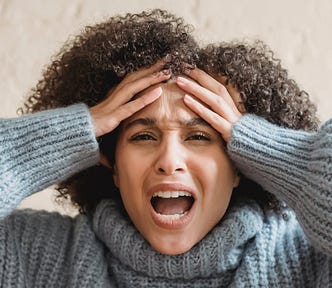 Emotional black woman yelling and touching head