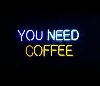 Neon sign that reads “You Need Coffee”