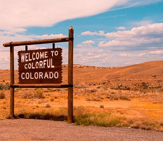 Welcome to Colorado sign against landscape (day trips from Denver)