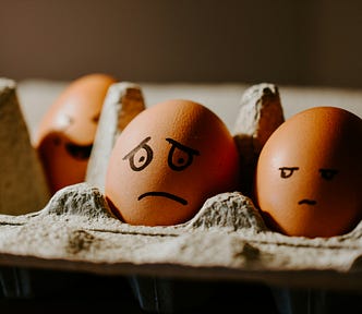 Egg with a sad face drawn on it