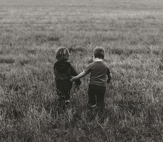 While camping in Idaho, my little boy and nephew walked under a decaying wooden fence with a no trespassing sign on it. Before calling them back, I took a few quick photos to remember their first steps of rebellion.