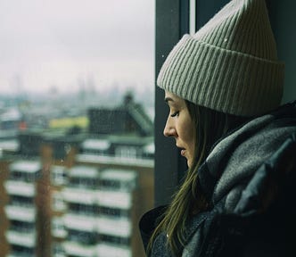 A woman looking out of a window.