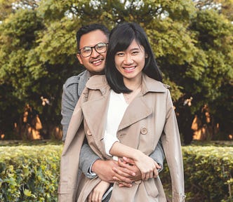 A happy couple hug and smile