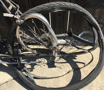 The gnarled remains of the bicycle the author’s husband was riding when he was hit and killed.