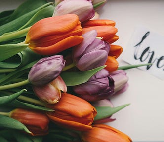 A bouquet of tulips and the word love.
