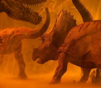 Dinosaurs around an orange atmosphere and dust