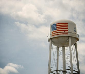 Rural water tower with American flag painted on the side