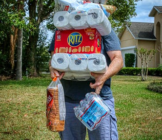Man balancing grocery items